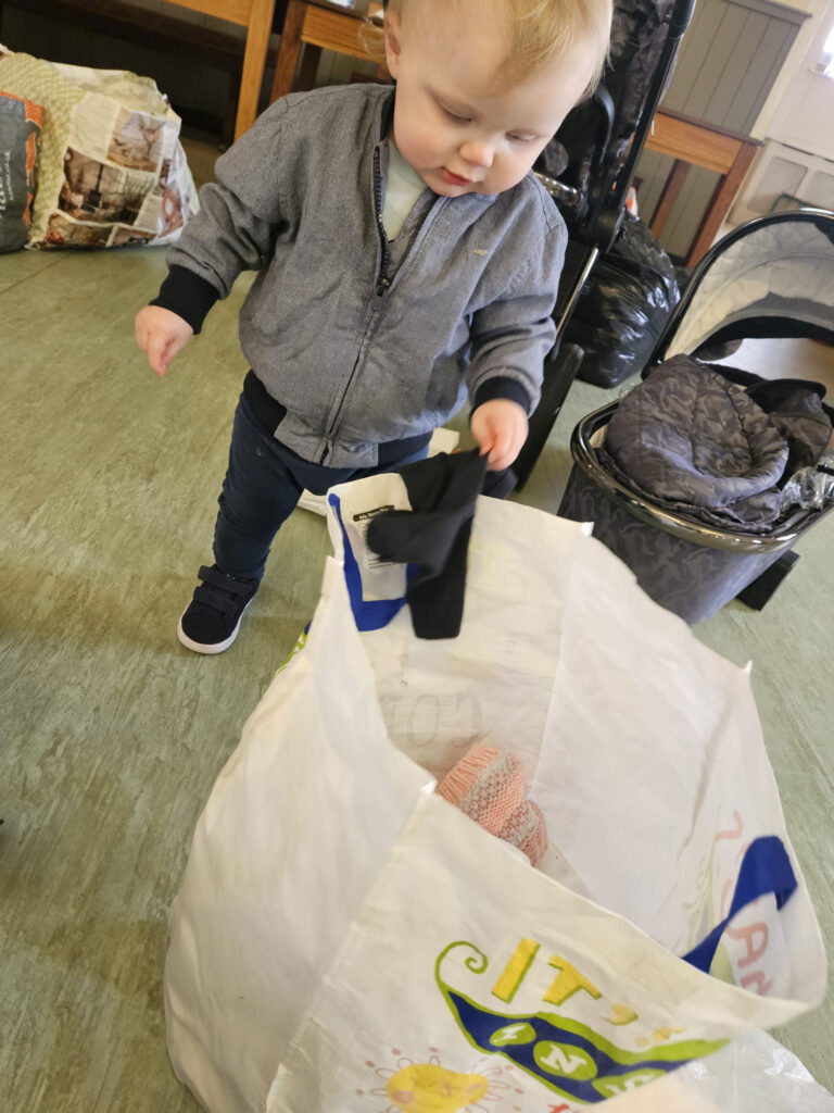 young child looking through donations to the community wardrobe