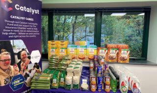 Catalyst team steps up to make donation to food bank